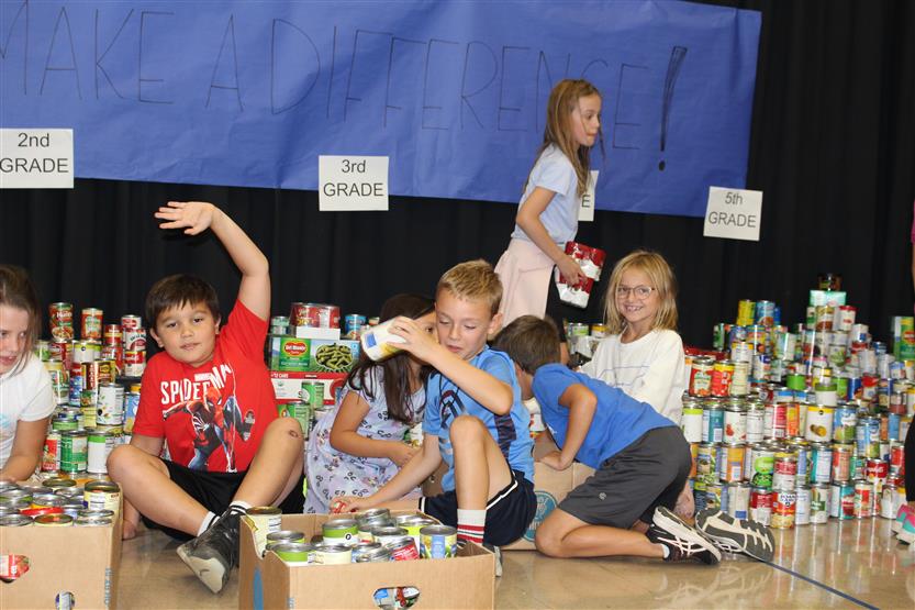 Students collect food for a can drive
